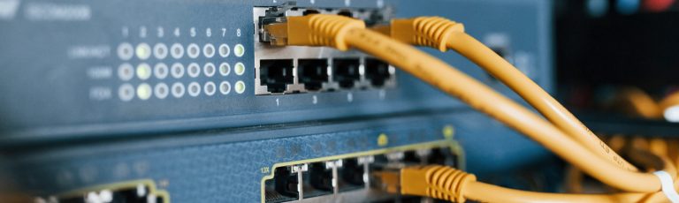 Close up view of internet equipment and cables in the server room.